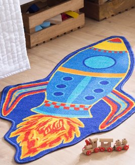 Blue and yellow space rocket shaped rug, powered by a tailf of fire.