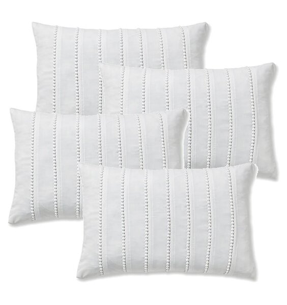Small white, oblong bolster cushion covers with rows of small pom pom details.