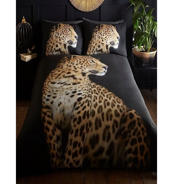 Full size, photographic quality image of a  leopard on a black background. The pillowcases show the leopard's head.