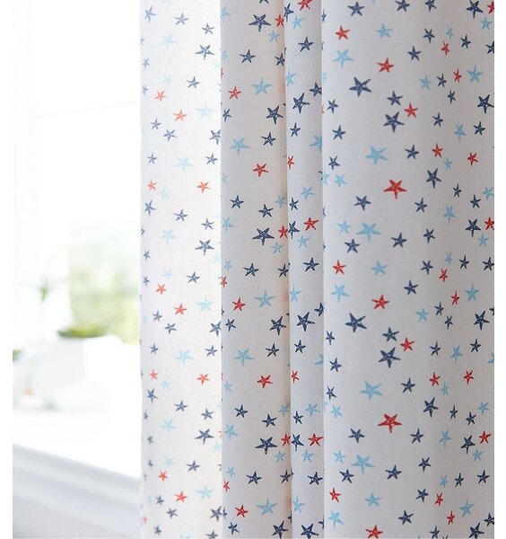 White curtains patterned with small red, blue and pale blue stars.