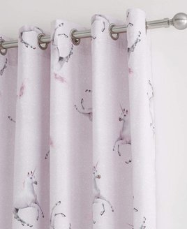 Pale pink and white speckled curtains with a white unicorn pattern.