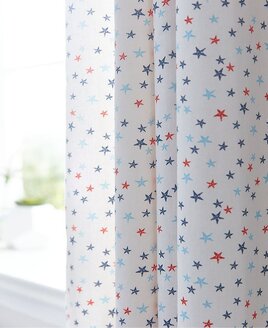 White curtains patterned with small red, blue and pale blue stars.